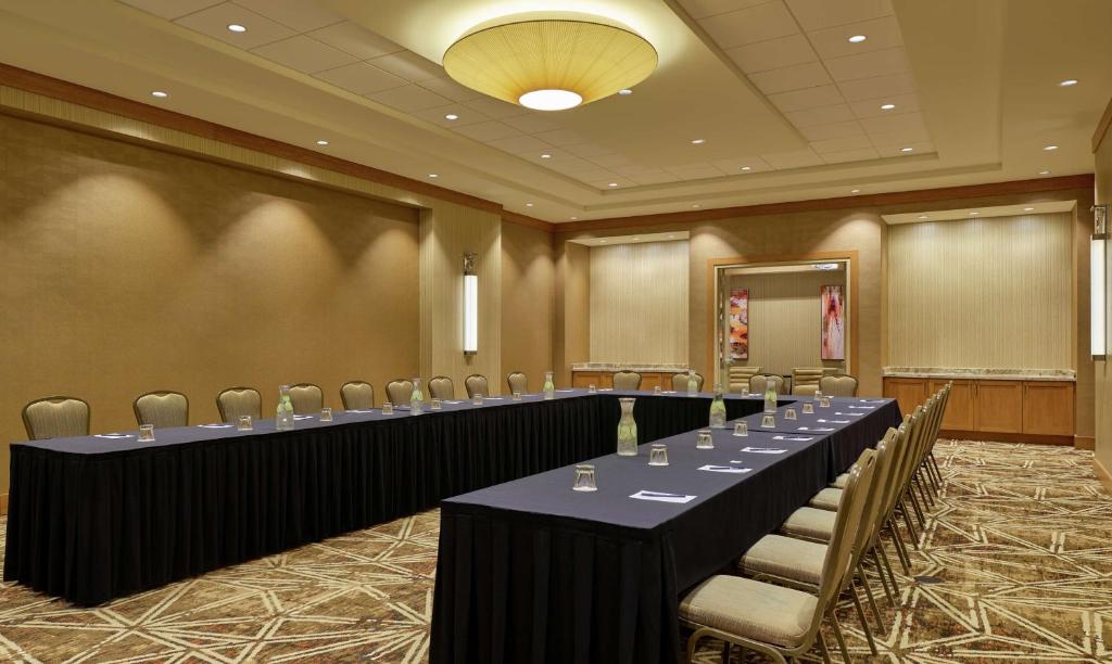 a conference room with long tables and chairs in it at DoubleTree by Hilton Houston Intercontinental Airport in Houston