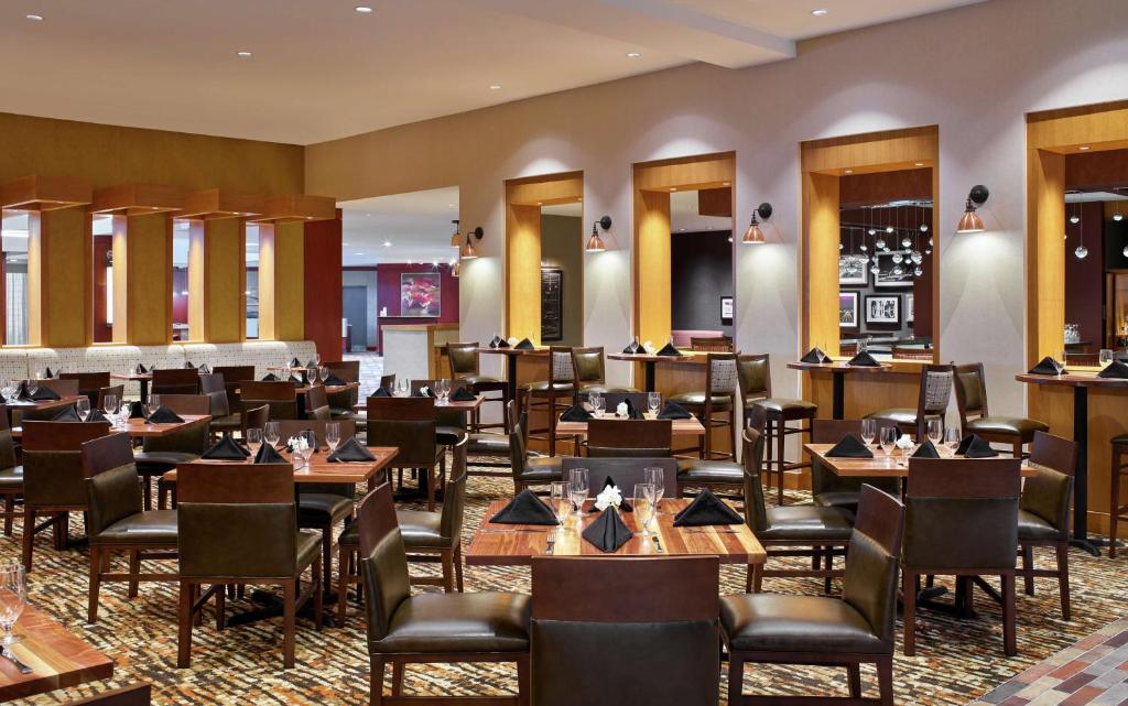 a dining room filled with tables and chairs at DoubleTree by Hilton Houston Intercontinental Airport in Houston