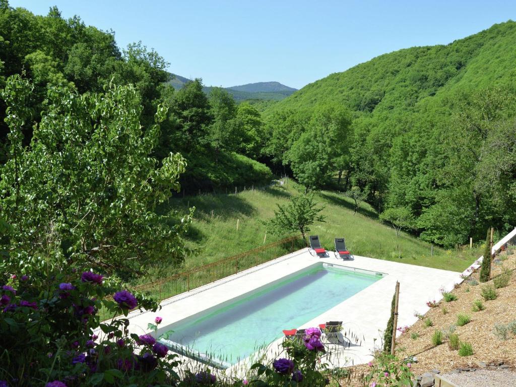 a swimming pool with a view of a river at Luxury country house with heated private pool in Courniou