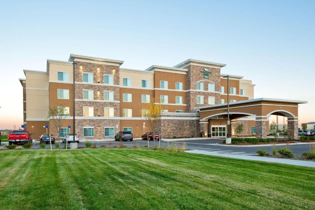 a large building with a lawn in front of it at Homewood Suites by Hilton Greeley in Greeley