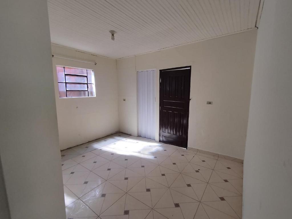 an empty room with a door and a tile floor at Kitnet in Ponta Porã