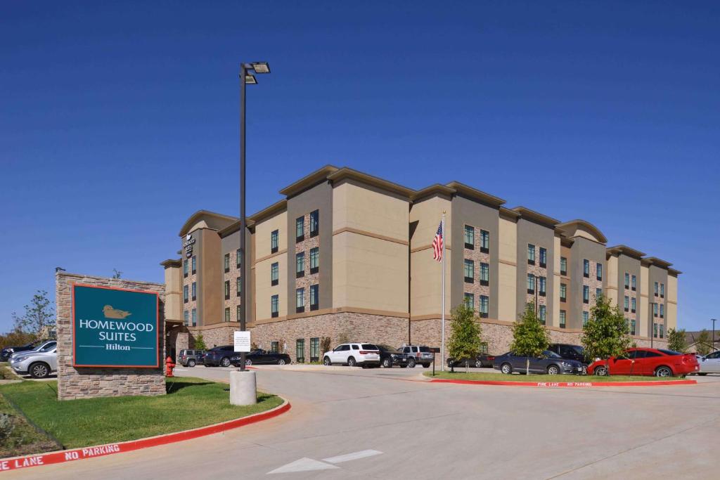 a large building with a sign in a parking lot at Homewood Suites by Hilton Trophy Club Fort Worth North in Trophy Club