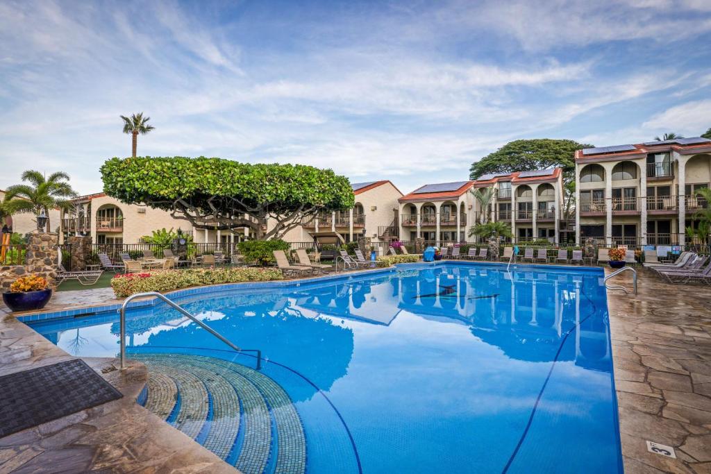 a pool at a resort with blue water at Aston Maui Hill in Wailea
