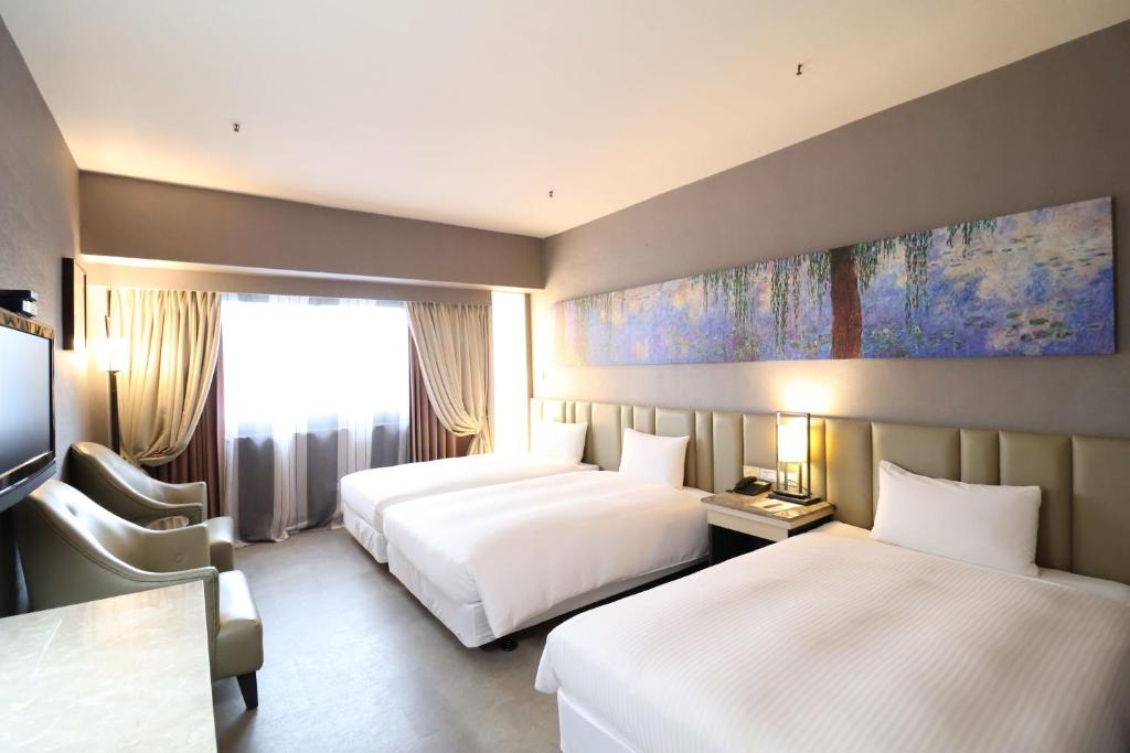 Postel nebo postele na pokoji v ubytování Kaohsiung Ahotel