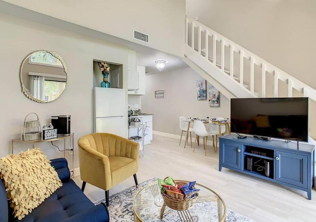 a living room with a blue couch and a tv at Charming Lakeview Retreat in Orlando