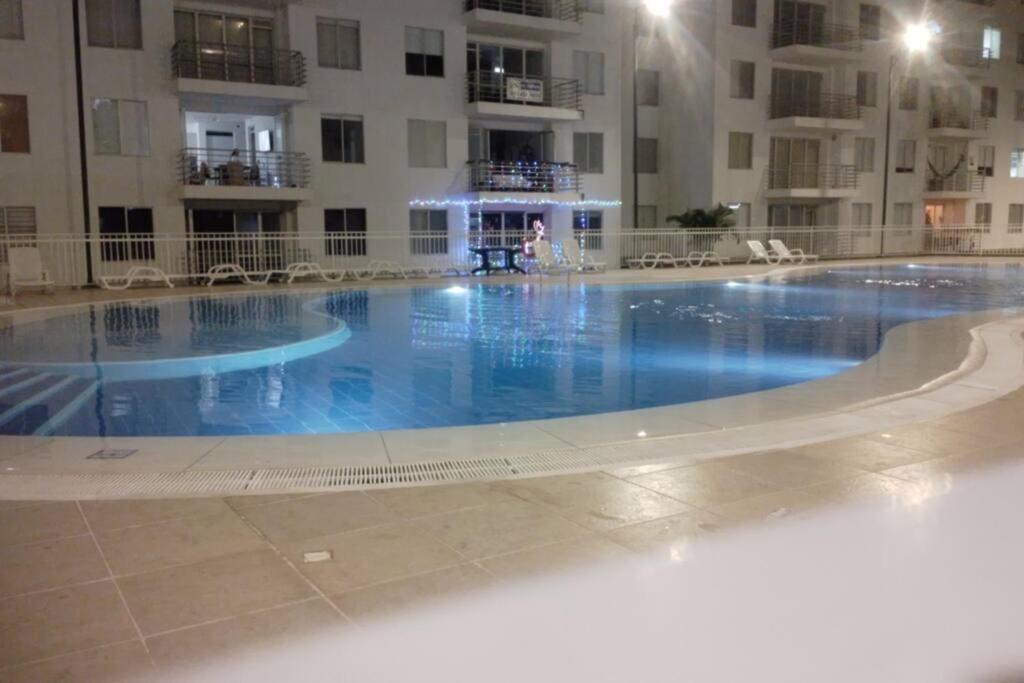 a large swimming pool in front of a building at para estrenar girardot in Soacha