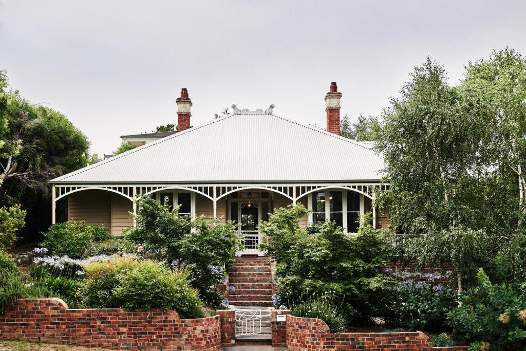 a house with two chimneys on top of it at Luxury Bendigo Stay in Golden Square