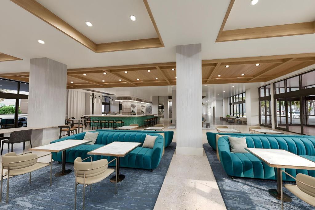 a lobby with blue couches and tables at Palmetto Marriott Resort & Spa in Palmetto
