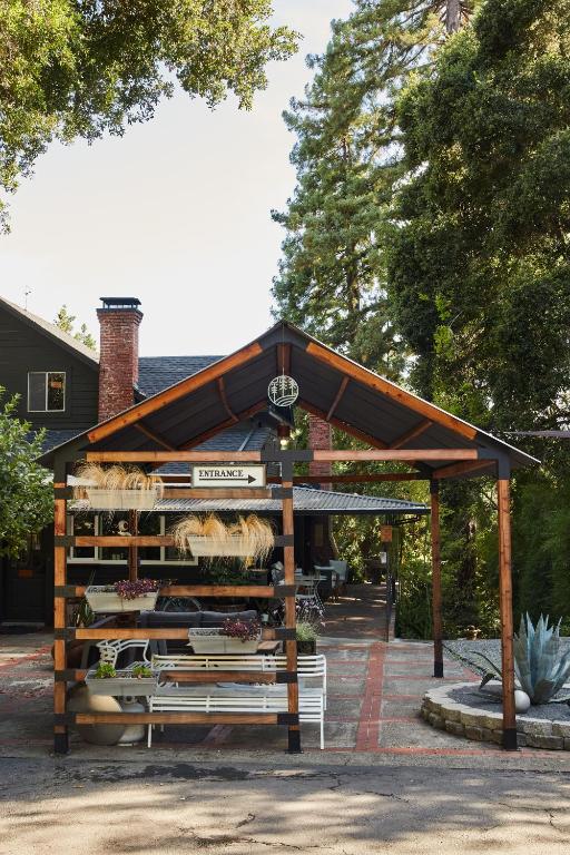 a vegetable stand with a bench in a park at Mine and Farm, The Inn at Guerneville, CA in Guerneville
