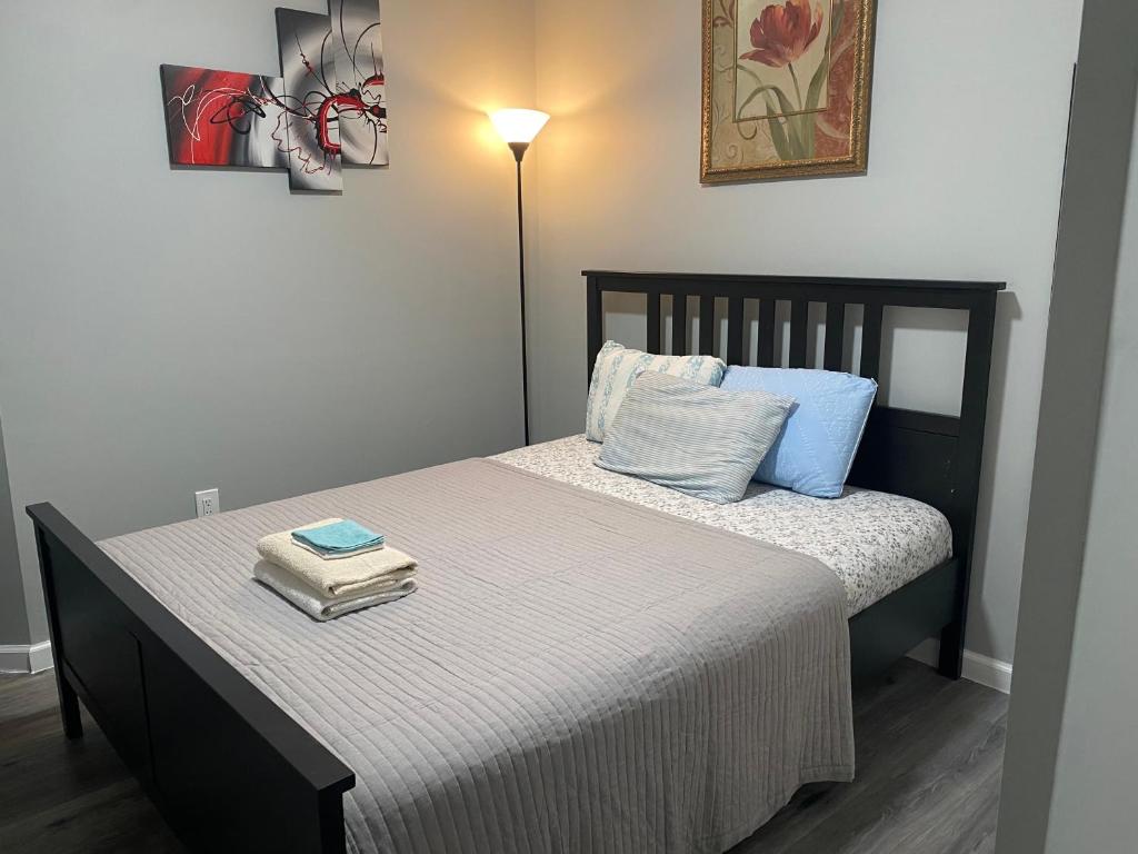 a bedroom with a bed with two books on it at Cozy Getaway Room in Newark