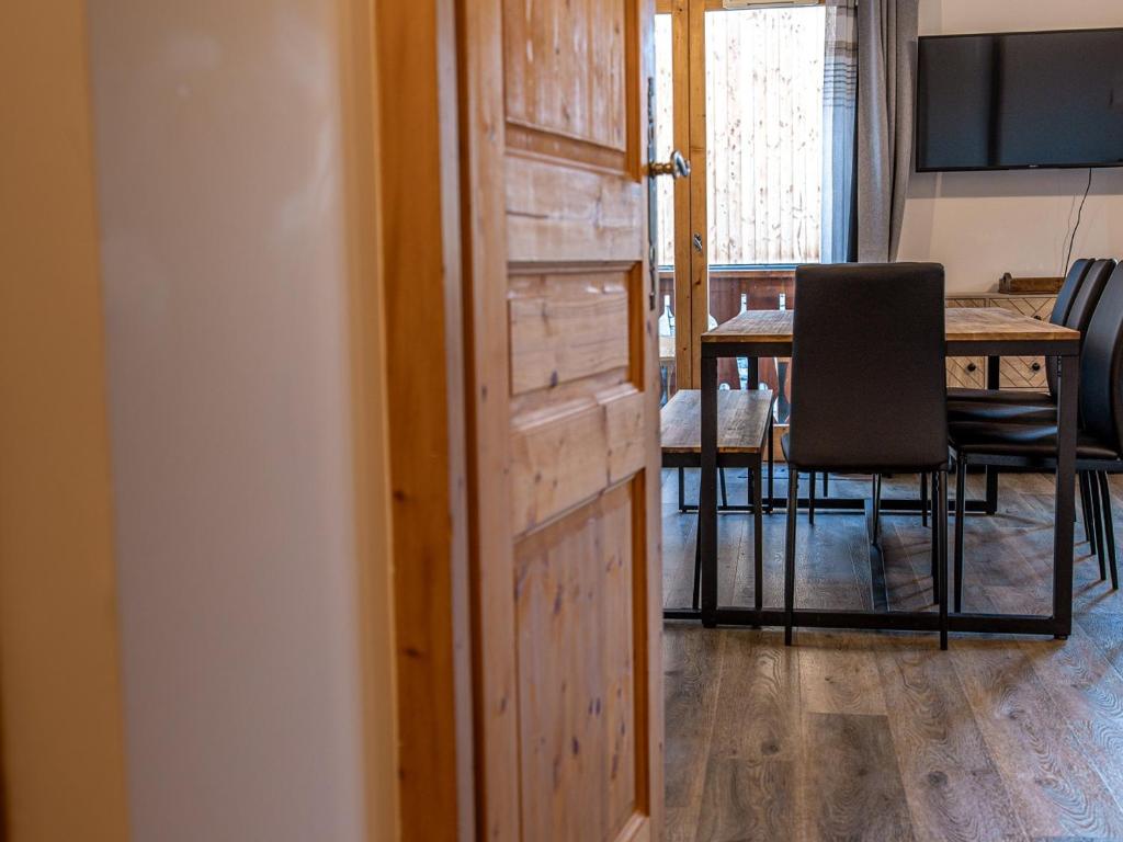 a door to a room with a table and a dining room at Chalet Plagne Soleil, 4 pièces, 8 personnes - FR-1-351-83 in Plagne Villages