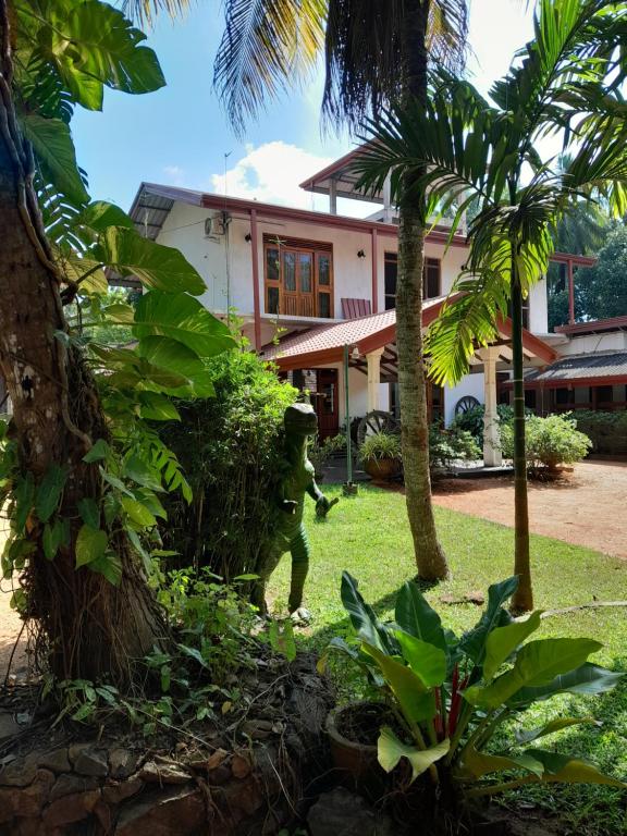 a statue of a man standing in front of a house at Sisila Guest House in Anuradhapura