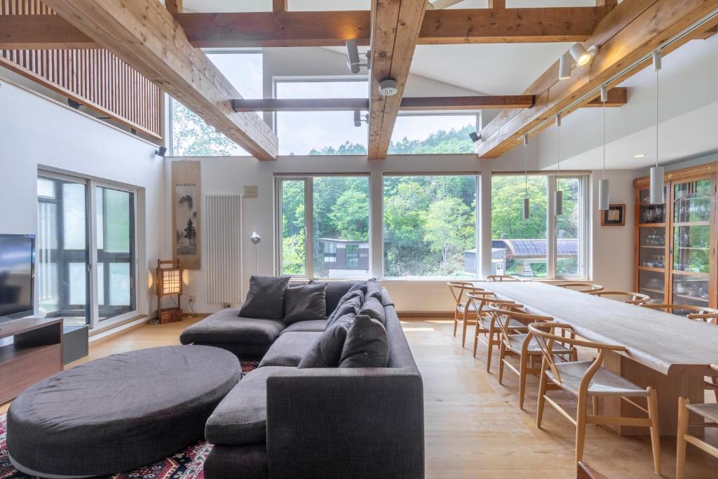a living room with a couch and a table at Chalet Murasaki in Niseko