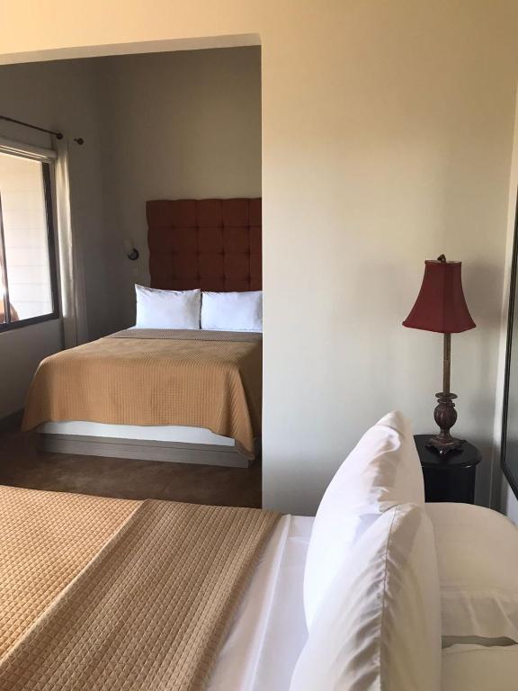 a bedroom with a bed and a lamp in it at Rancho Humo Estancia in Puerto Humo