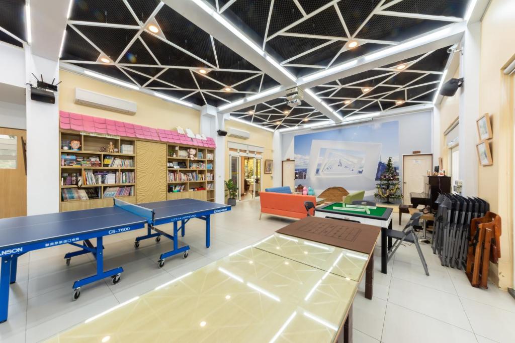 a library with two ping pong tables in it at 光腳丫宜蘭民宿 in Dongshan