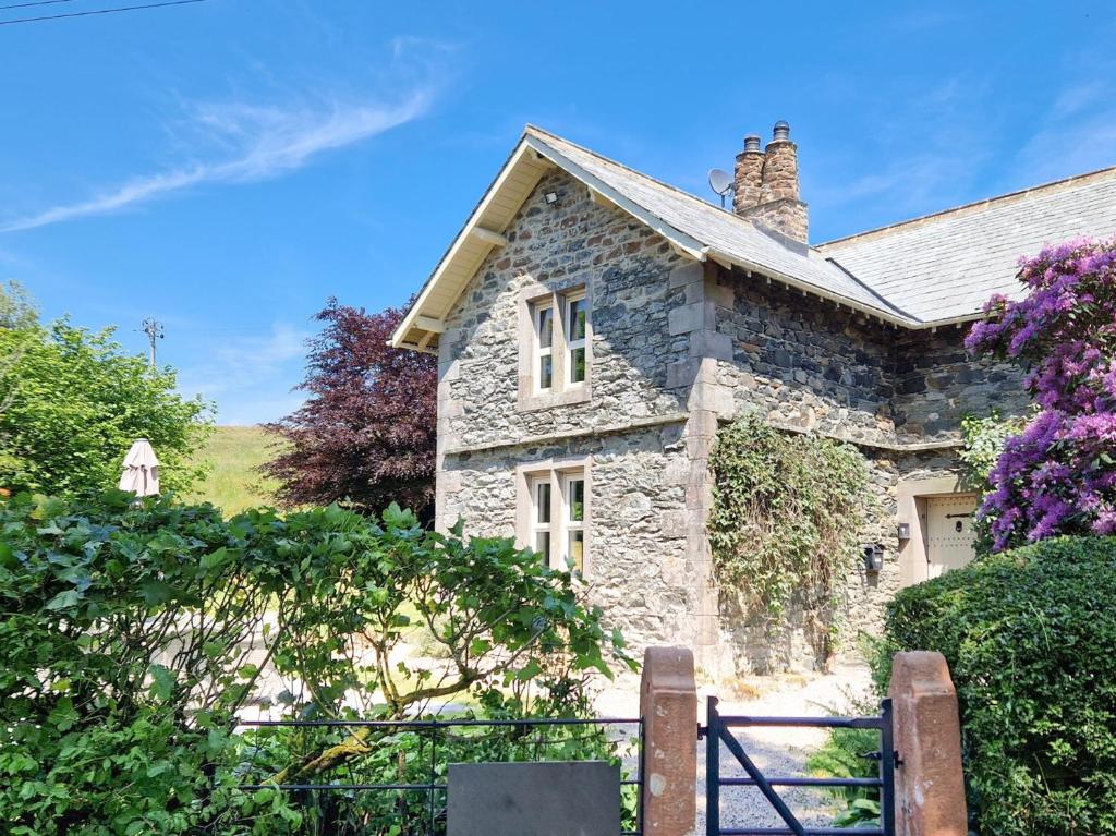 a stone house with a gate in front of it at 4 Bed in Ullswater 88023 in Dockray