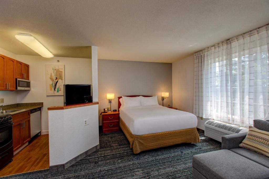 a hotel room with a bed and a kitchen at TownePlace Suites Denver Southwest/Littleton in Littleton