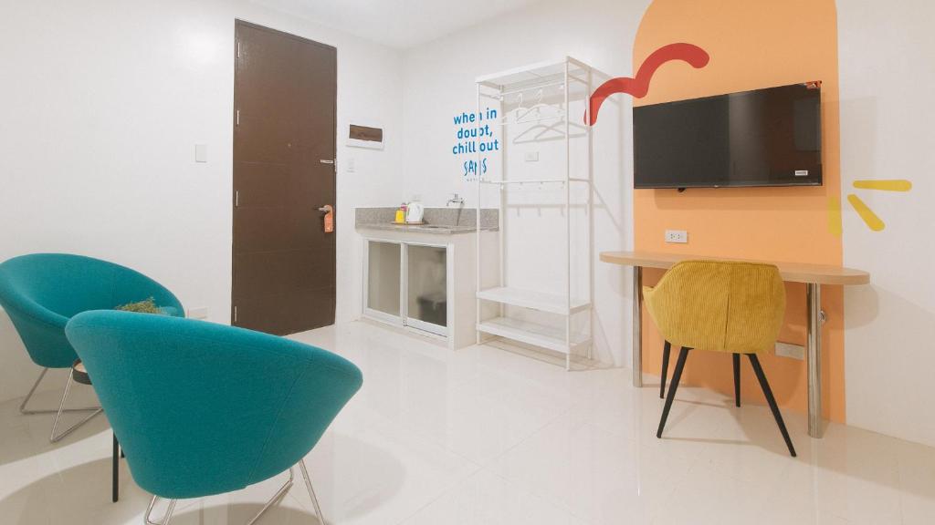 TV a/nebo společenská místnost v ubytování Sans Hotel at One JD Place Makati by RedDoorz