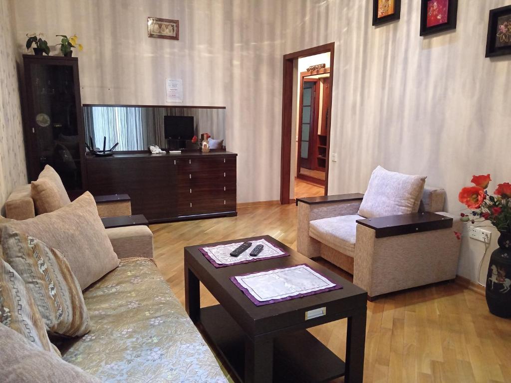 a living room with a couch and a table at My sweet home on Gadzhibekova 105-119 in Baku