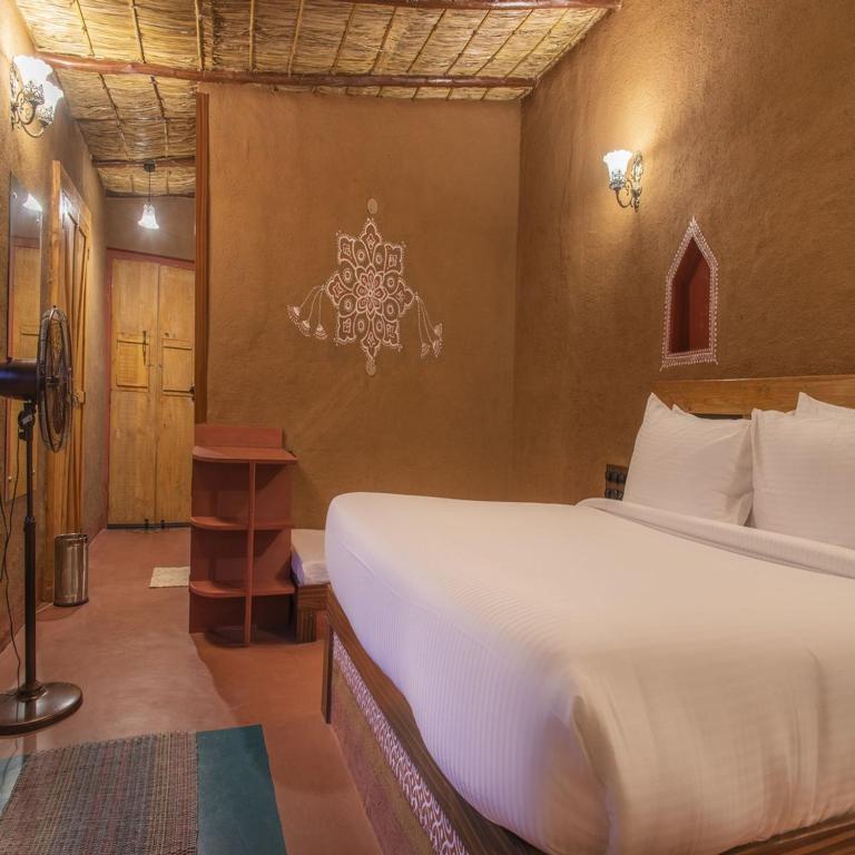 a bedroom with a large bed in a room at Hotel Aanandwan Palace in Varanasi