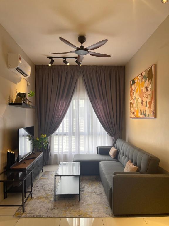 a living room with a couch and a ceiling fan at DnQ Homestay at The Horizon with Netflix, LG Purifier,Wifi in the Centre of Ipoh in Ipoh