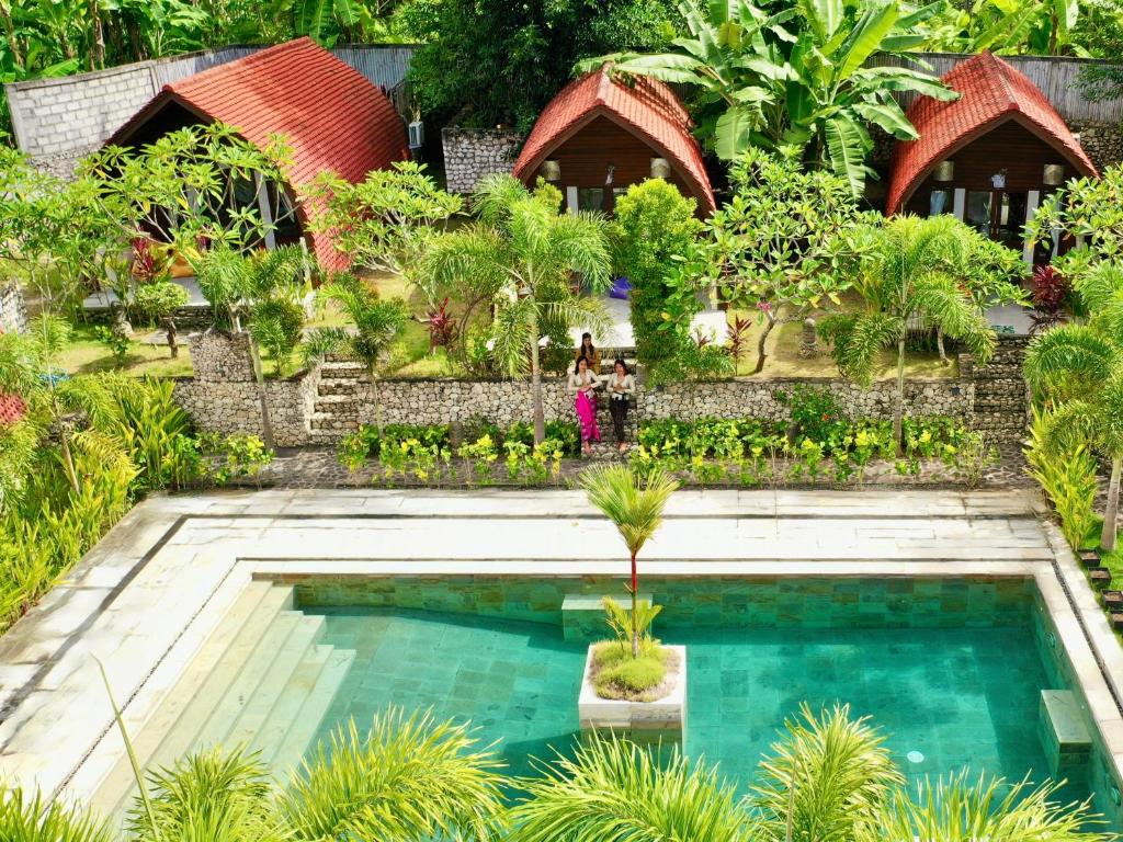 a swimming pool in the middle of a garden at Jungle Paradise in Nusa Penida