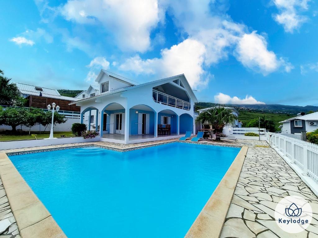 a house with a swimming pool in front of it at Villa Aldabra - 3 etoiles avec piscine à Saint-Leu in Saint-Leu