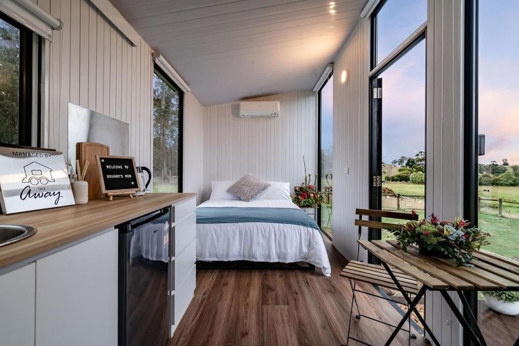 a bedroom in a tiny house with a bed at Brumby's Run 