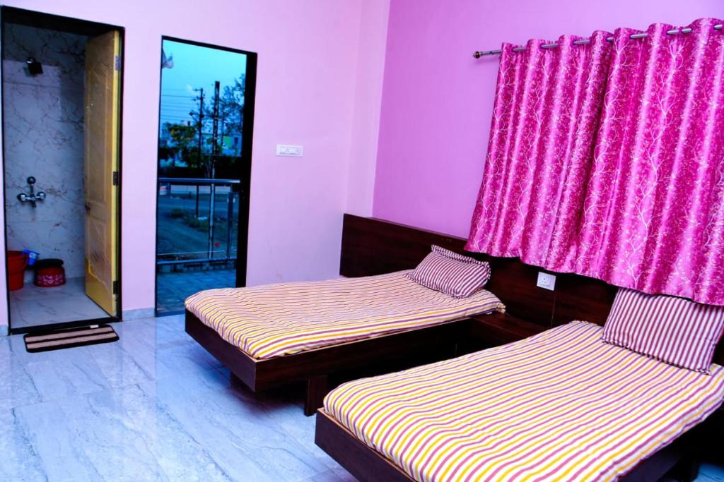 A bed or beds in a room at krushna yatri dham