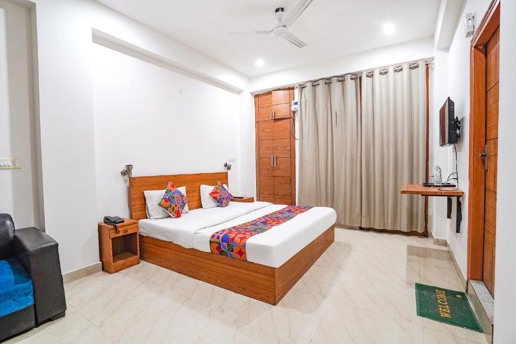 a bedroom with a bed and a television in it at FabHotel Prime Residency in New Delhi