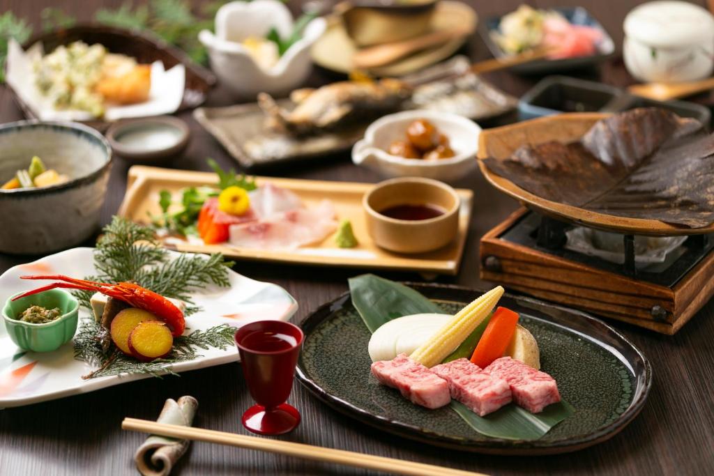 a table topped with plates of food and chop sticks at Onyado Hisui in Takayama