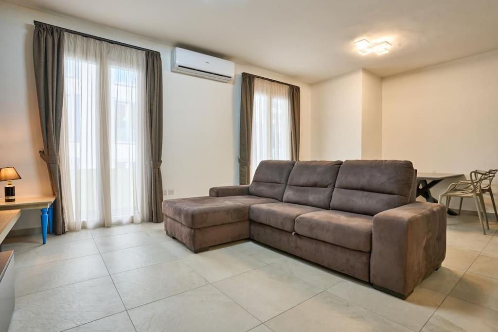 a living room with a brown couch in a room at 2 Bedroom Apartment St. Julians in St Julian's