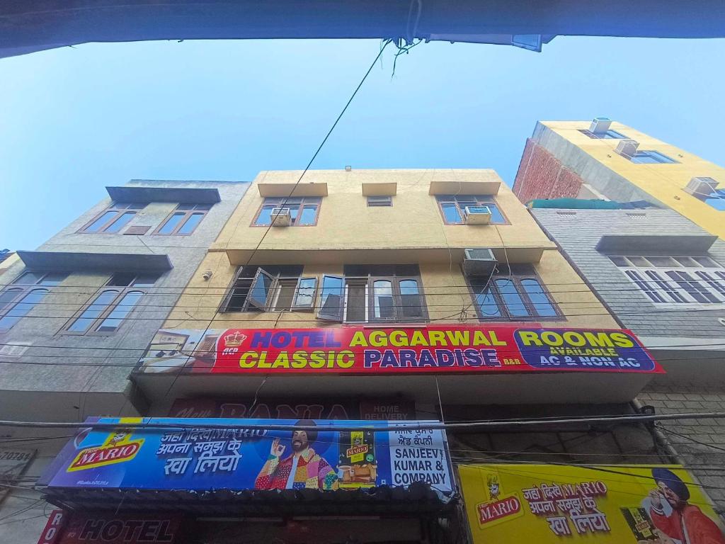 a tall building with a sign in front of it at OYO Aggarwal Classic Paradise in Amritsar