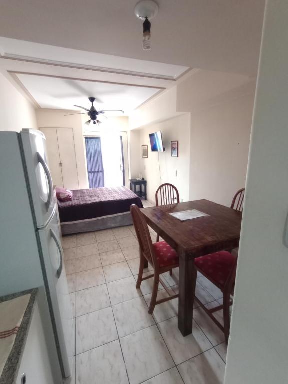 a kitchen and dining room with a table and a bed at Alquiler temporal in San Miguel de Tucumán