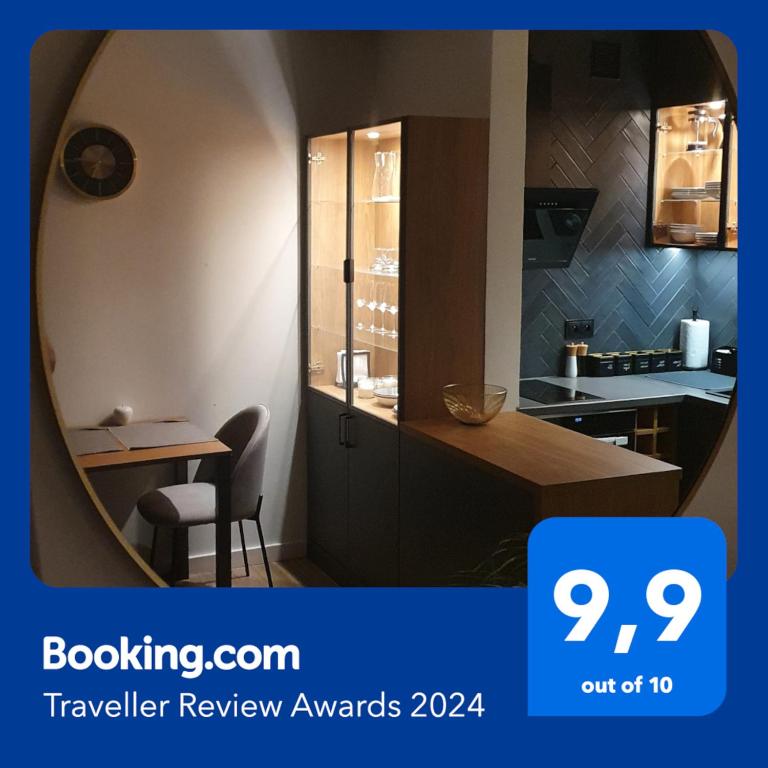 a kitchen with a table and a mirror at Apartment Between in Kraków