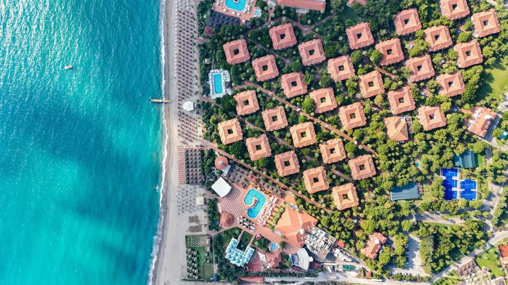 an aerial view of a group of houses next to the water at Ali Bey Club & Park in Kizilagac