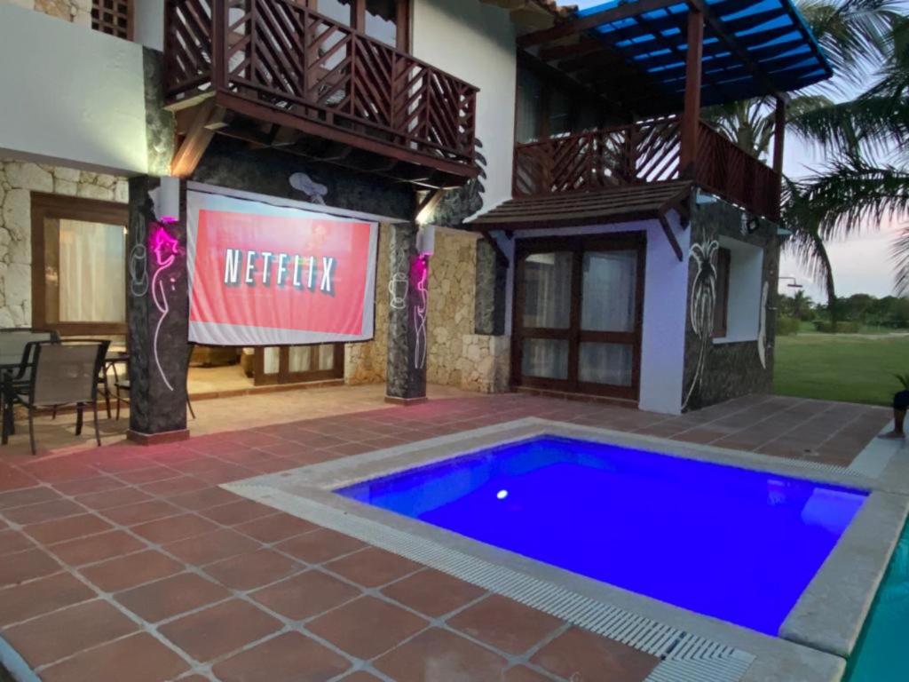 a swimming pool in front of a house at Golf Views Near Bayahibe & Casa De Campo in La Romana