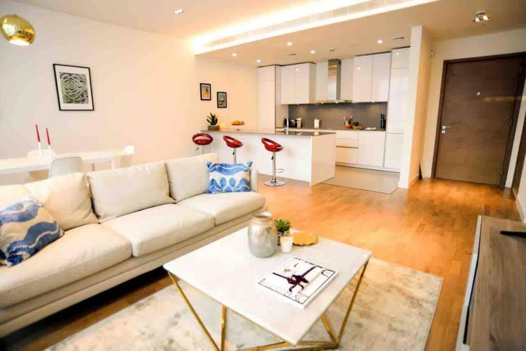 a living room with a white couch and a table at The perfect CityWalk 1 BR in the heart of Dubai in Dubai