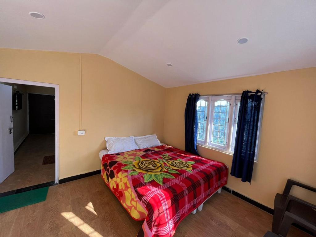 a bedroom with a bed and a window at Heath cote in Ooty