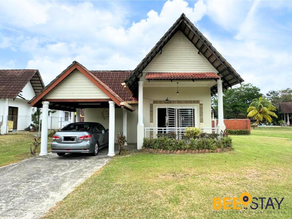 a house with a car parked in the driveway at Melaka Afamosa DAmour Villa 12PAX with Private Pool & BBQ in Kampong Alor Gajah