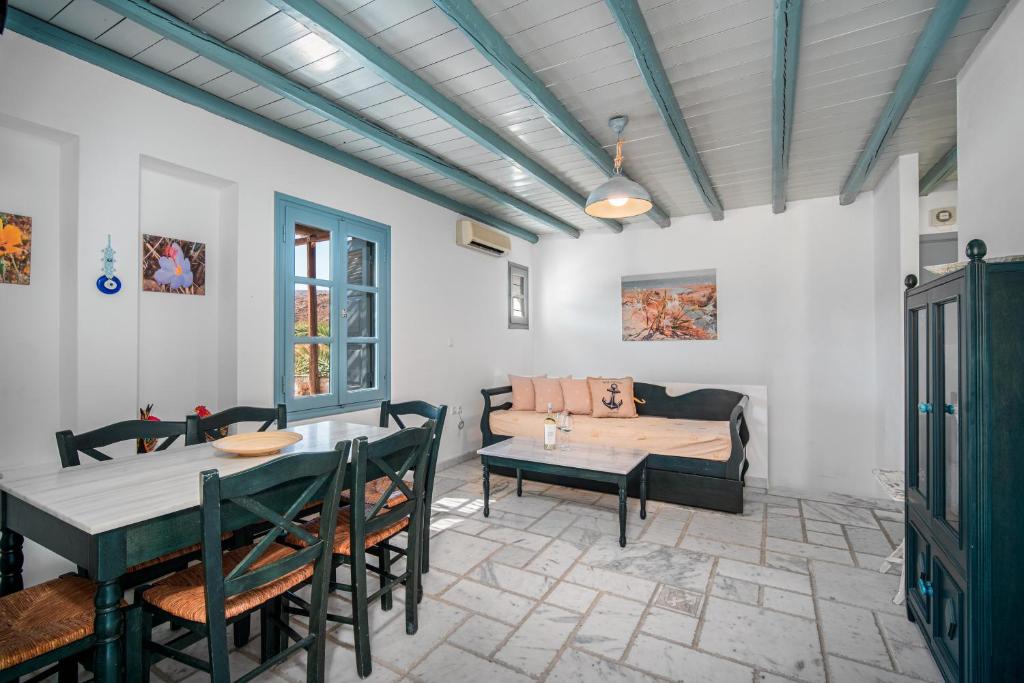 a living room with a table and a couch at Ammos 1 in Serifos Chora