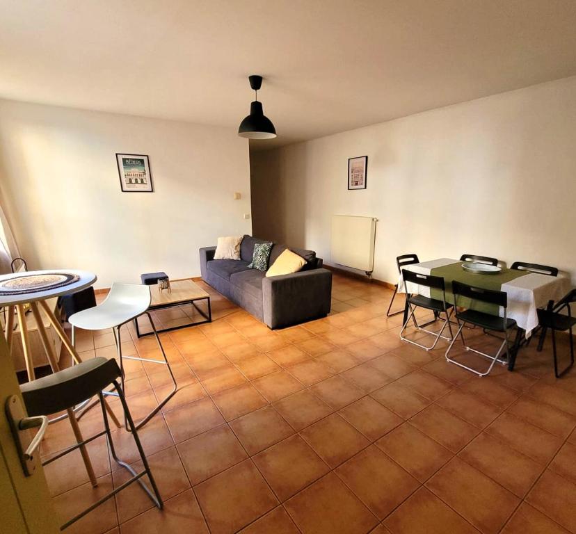 a living room with a couch and a table and chairs at Situation parfaite, calme et spacieux, Wifi fibre, Netflix & Prime in Béziers