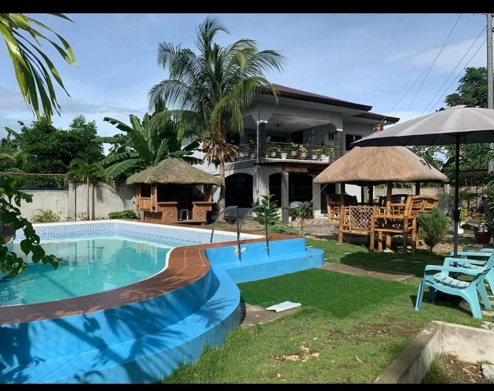 uma villa com piscina em frente a uma casa em WCW Auberge em Saavedra