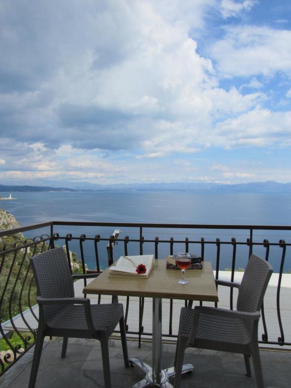 a table and chairs on a balcony with a view of the ocean at Kallisto studios in Gythio