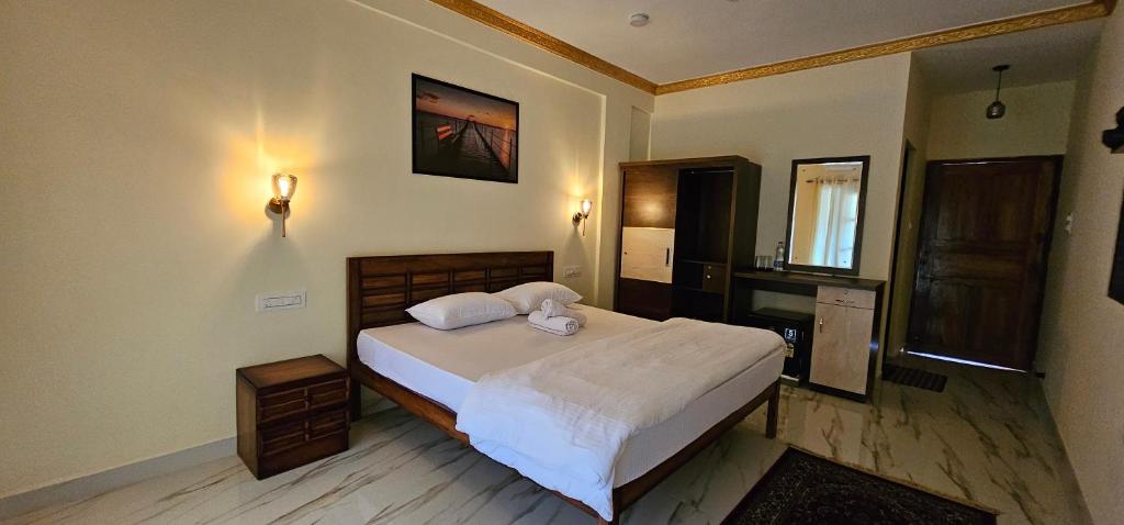 a bedroom with a bed with two pillows on it at Divine Kingdom at Abba's Agonda in Agonda
