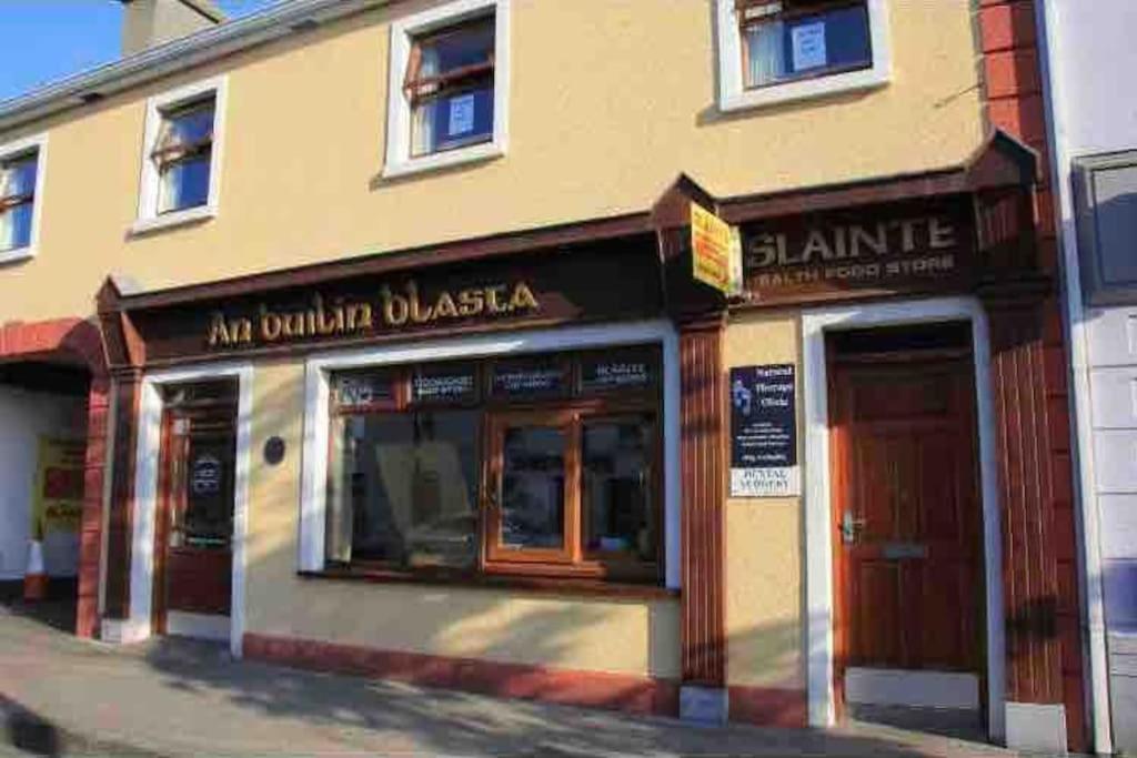a store front of a building with two doors at Barber’s hall town center apartment in Belmullet
