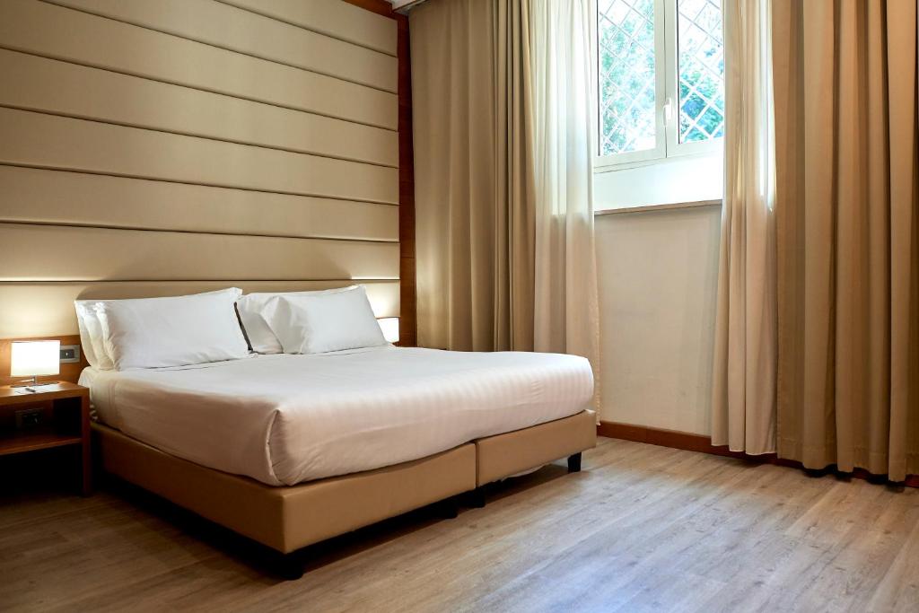 Postel nebo postele na pokoji v ubytování Occidental Aurelia