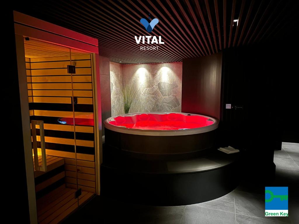 a bathroom with a red tub in a room at Aparthotel Vital - Vital Resort in Moravske-Toplice