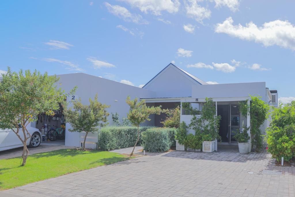 a white house with trees and a driveway at Lily's Rest, Village on Silwerstrand, Robertson in Robertson