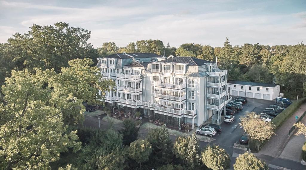 an aerial view of a large white building at The Cozy Hotel & Lofts Timmendorfer Strand in Timmendorfer Strand